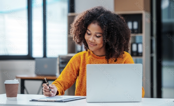A woman using a laptop to manage her conveyancing process with LPL, ensuring a smooth and efficient property transaction.